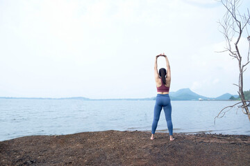 The asian woman do yoga at home in holiday time, on modern concept and healthy. Nature  background with exercise and nature, female happiness concept