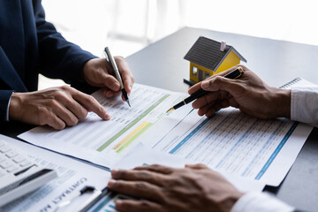 Businessman and Real Estate Broker Marketing planning and discussion at real estate brokerage...