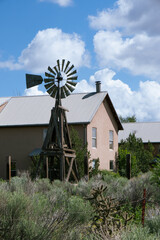 A house and windmill in the countryside of Santa Fe, New Mexico. USA.