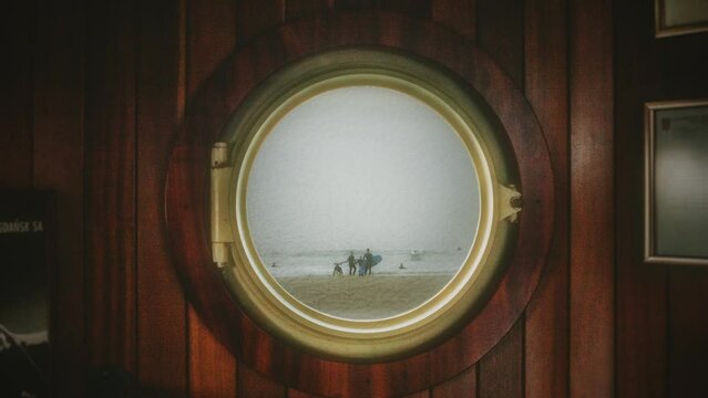 Beach Surfers Door Viewer Zoom In Ocean Waves Shore. Group of surfers on a beach view from a door viewer, zoom in. House interior