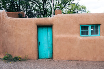 Adobe House with Turquoise Door Entrance