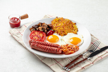 Portion of english breakfast with eggs and sausages