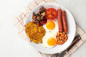 Portion of english breakfast with eggs and sausages