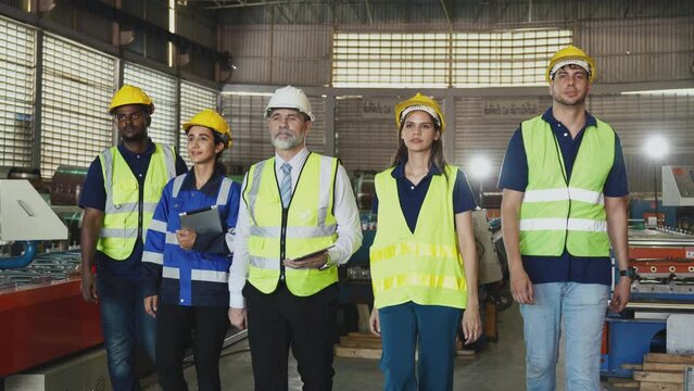 Group of diverse engineering and worker finished work and walking together, Team showing unity and teamwork in factory workplace, Industrial and manufacturing happy people at work concept.