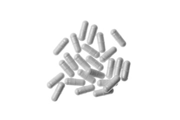 scattered tablets - vitamins in transparent capsules, on an isolated transparent background top view