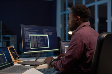 African American developer concentrating on development of software on computer