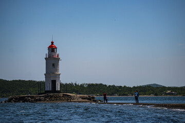 lighthouse in a sunny day in the sea. High quality photo