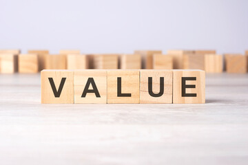 word VALUE inscribed on wooden cubes lying on a light table. economy and investments concept.