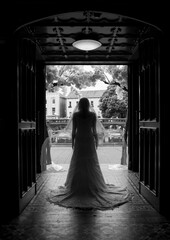 silhouette of a bride facing out the front door of a church