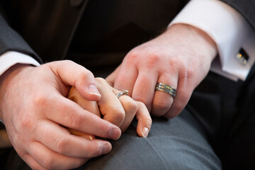 hands of the groom and bride with wedding rings