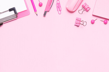 Creative office desktop with pink stationery set on pink background with copy space for your design.