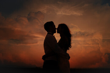 Lovers before kissing at the sunset