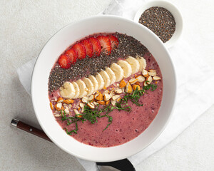 Portion of healthy smoothie bowl with banana and strawberries