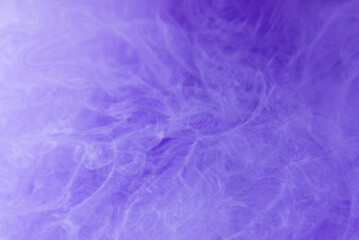 Ink water mist motion.Paint water drop. Neon purple blue fume moving on abstract blurred defocused background.