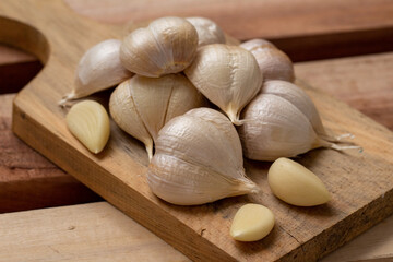 Garlic, garlic slices, garlic cloves, on a wooden tray