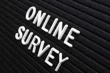 The phrase online survey on black letter board