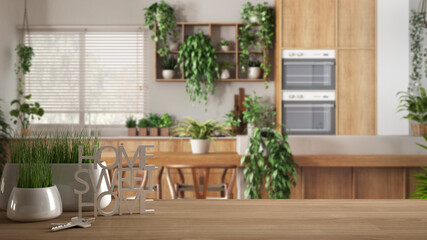 Wooden table, desk or shelf with potted grass plant, house keys and 3D letters home sweet home, over kitchen and dining room, architecture interior design, urban jungle