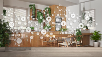 Tablet wireless with smart home app on wooden table, connected line and dots background showing internet of things system, home automation concept, kitchen and dining room