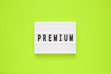 The word premium on lightbox isolated green background. Premium Membership Concept.