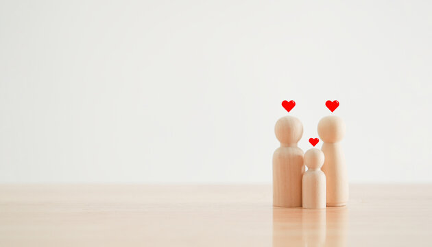 Happy family with one child and heart emotion on wooden background. Wood doll character. Togetherness relationship and lifestyle concept.