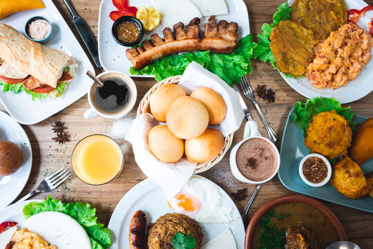 Various delicious Latin American dishes with coffee and juices served on table