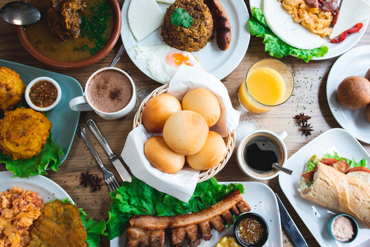 Various delicious Latin American dishes with coffee and juices served on table
