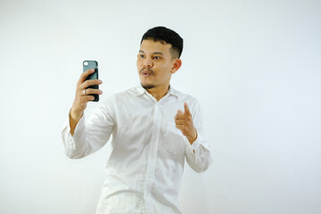 Adult Asian man holding mobile phone showing enthusiastic expression