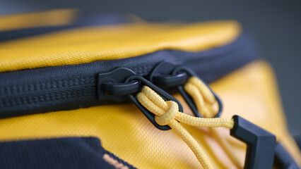 Yellow and black zipper on sports backpack closeup. Accessories for sewing bags concept