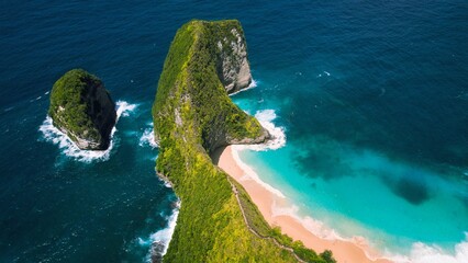 Pristine sandy Kelingking Beach on Nusa Penida island Bali. Turquoise ocean water by green limestone cliffs. Famous natural landmark.