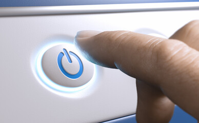 Finger pressing a power button to start an electronic device.