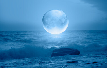 Full crystall moon (or glass ball moon) rising over empty sea with night 