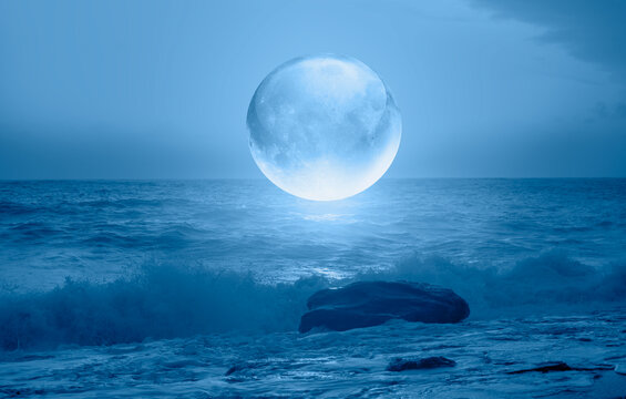 Full crystall moon (or glass ball moon) rising over empty sea with night © muratart