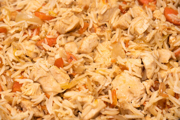 Tasty pilaf with chicken as background.
