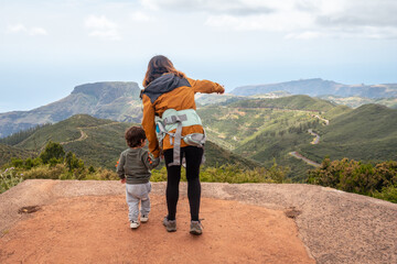 Obraz na płótnie Canvas Mother and son looking at the views from the top of Garajonay on La Gomera, Canary Islands