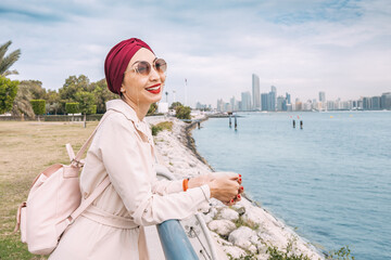 With the radiant sun shining down on her, an Indian girl proudly wears her turban as she takes a peaceful walk along the Abu Dhabi embankment, enjoying the natural beauty and tranquility of the city.