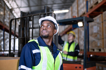 African-american male worker looking away in warehouse. Freight transportation and distribution...