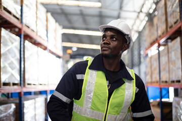 African-american male worker looking away in warehouse. Freight transportation and distribution...