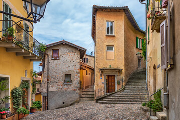 Fototapeta na wymiar Narrow cobblestone streets in the picturesque Morcote village on the Lake Lugano. Switzerland. Morcotte is considered 