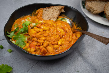 Vegan bean curry bowl, served with bread slices