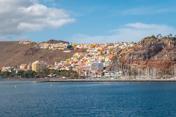 Fototapeta premium View of the city and the port of San Sebastian de la Gomera seen from the ferry heading to Tenerife. Canary Islands