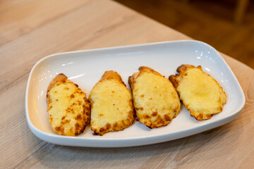 Grilled Cheese on Yellow Bread Placed on a white plate on the table in a restaurant, look at the eating