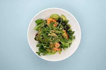 Portion of healthy gourmet shrimp salad with avocado