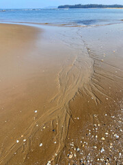 Artistic formation on the beach due to high tide and low tide.