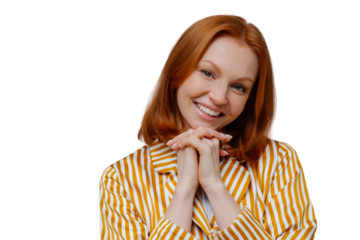 Adorable young European woman looks positively at camera, keeps hands together under chin, wears striped pajamas, has pleasant talk with husband, isolated on grey studio wall. People, home, rest