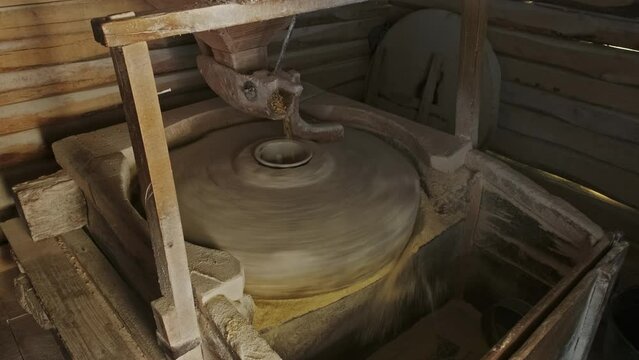 Working old water powered grist mill made of stones and wood, 4k