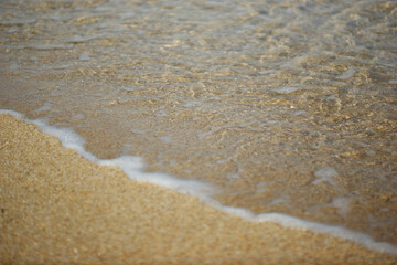 Fototapeta na wymiar Sea water rushes into the sandy beach