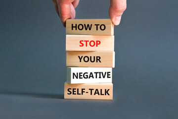 Stop negative self-talk symbol. Concept words How to stop your negative self-talk on wooden block. Psychologist hand. Beautiful grey background. Psychological negative self-talk concept. Copy space