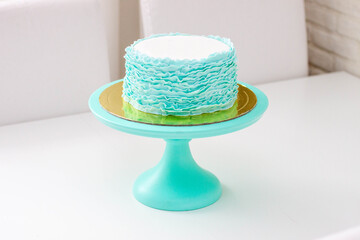 Exquisite birthday Cake Decorated with Green and turquoise Fondant Ruffles on white background