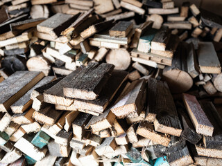 Dry firewood stacked in a pile, chopped wood for winter heating fuel of the fireplace. Natural wood background.