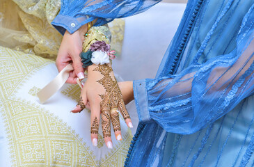 Moroccan woman with traditional henna painted hands
